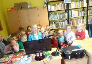 Pani Małgorzata Hofamnn prezentuje dzieciom narzędzia pracy bibliotekarza.